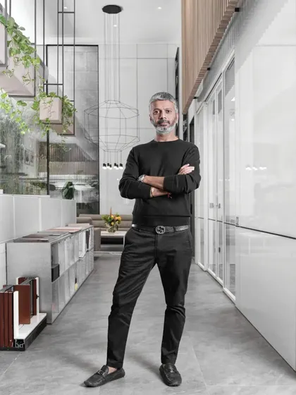 A portrait of our founder, Ar. Sumit Dhawan, in our office. The space is designed to be a living portfolio of our work, showcasing our approach to modern, minimalist, and functional design.