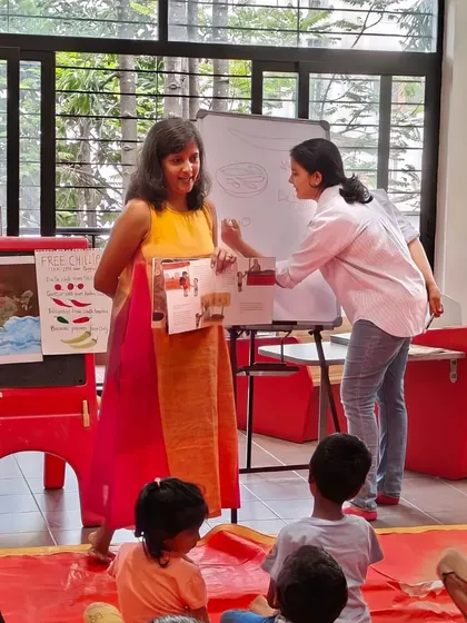 The author and illustrator showing the kids the beautiful pages of their new book. These moments of connection are what make my author sessions so special.