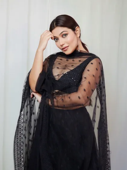 A gentle and engaging portrait from the same series. The sheer dupatta adds a layer of softness, and the model's expression is warm and inviting.