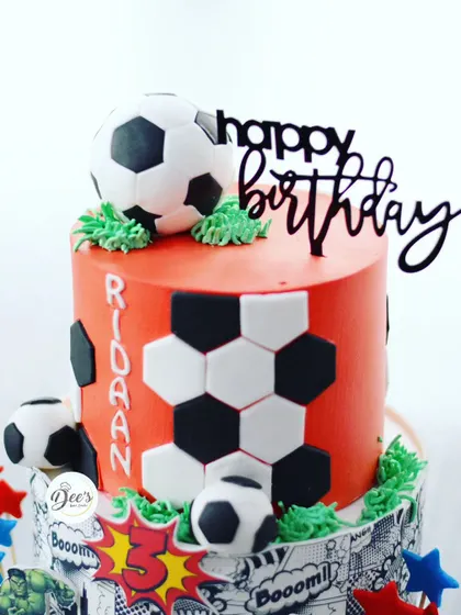 The top tier is dedicated to the birthday boy's love for football, complete with edible soccer balls.