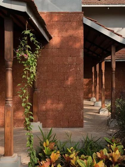 The veranda at Maison Rouge, with its reclaimed timber columns and laterite wall, is a perfect example of our approach to vernacular architecture.
