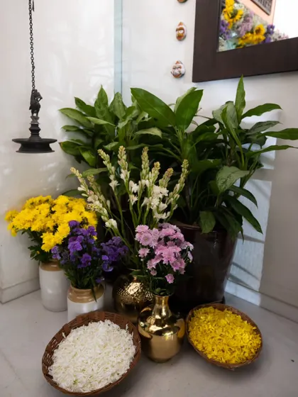 A similar arrangement to the one above, showcasing the thoughtful placement of traditional elements like the hanging lamp (diya) and fresh flowers.