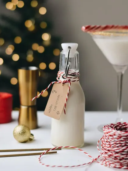 A bottle of homemade Christmas eggnog, presented as a thoughtful, festive gift with a hand-written tag.