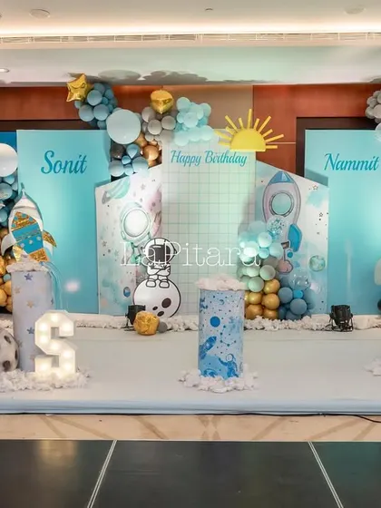 Another view of the indoor space stage, showing the careful placement of balloons, props, and lighting to create a visually stunning display.