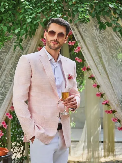 For the groom squad, I suggest a Rose Quartz pink linen jacket. It's a fresh, contemporary color that stands out at a summer wedding. Paired with white trousers, it creates a look that is both festive and elegant.