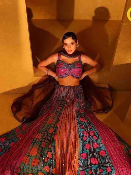 A perfect blend of vibrant hues and meticulous craftsmanship. This multi-colored sequin and floral lehenga is a true showstopper from the 'Samah' collection.