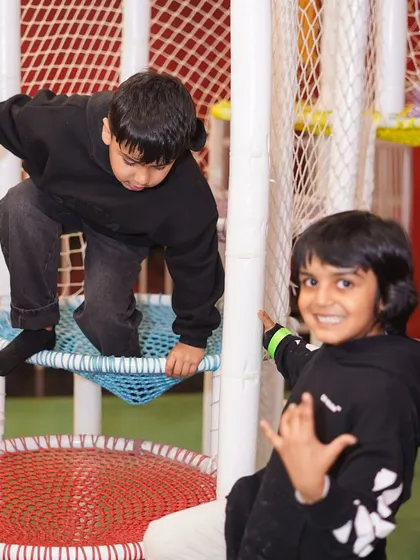 Brothers exploring the net climbers in our soft play area. It's a great space for siblings and friends to play together.