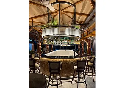 A full view of the stunning circular bar at the Karnataka Golf Association. Our greenery design acts as a living chandelier, providing a central focal point that is both functional and beautiful.