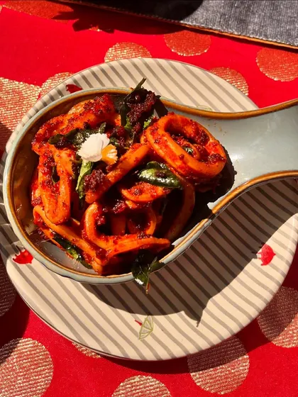 The Alleppey Squid Roast from our Christmas menu. Fresh squid is slow-cooked in the 'olarthu' style, ensuring every ring is coated in a smoky, spicy, and earthy masala.