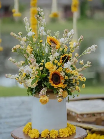 A lovely centerpiece of sunflowers and tuberose, perfect for a bright and cheerful Haldi or Mehendi event.
