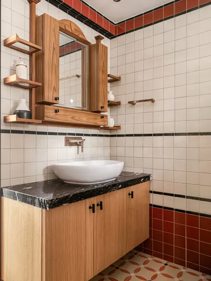 The vanity area features a custom-designed wooden mirror and cabinet, adding a touch of handcrafted warmth to the space.
