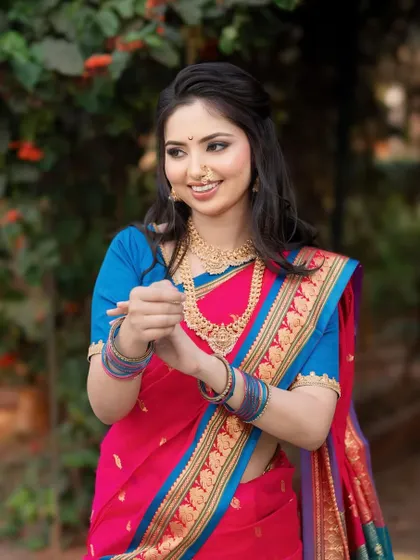 A happy and candid shot of our bride. Her hair is styled in loose waves with a half-updo, perfect for a more relaxed yet traditional wedding function.