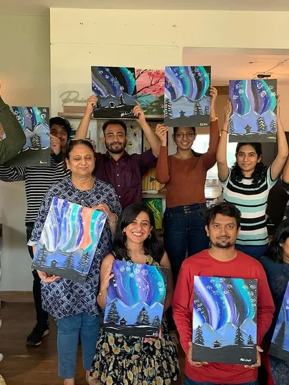 The whole crew proudly displaying their aurora paintings. The energy in the room was electric, and the results are absolutely magical. Such a fun night of art and memories.