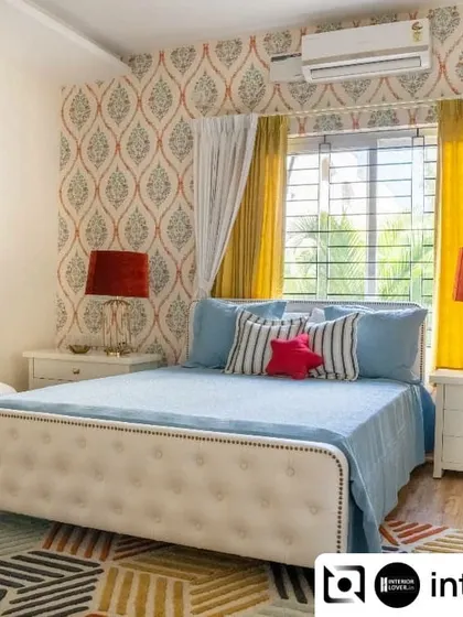 Color makes a kid's room come alive. This vibrant bedroom uses a playful mix of patterns and bright colors, from the geometric rug to the bold wallpaper and sunny yellow curtains, creating a cheerful and energetic space.
