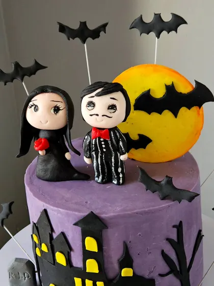 A close-up of the handcrafted toppers for the "RIP Singlehood" cake. I sculpted the couple in a gothic style to match the fun, spooky theme.