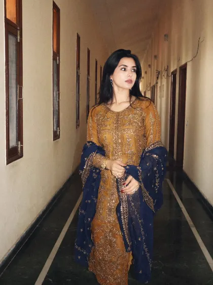 A side profile in the Asim Jofa outfit, highlighting the flow and design of the traditional attire.