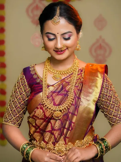 A beautiful bridal portrait in a rich purple and gold Kanjeevaram saree. The focus is on the intricate details of the blouse, jewelry, and the bride's serene expression.