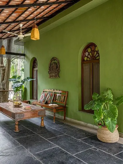 The long, shaded verandah outside the suites is furnished with antique benches, providing a perfect spot to relax and enjoy the garden views.