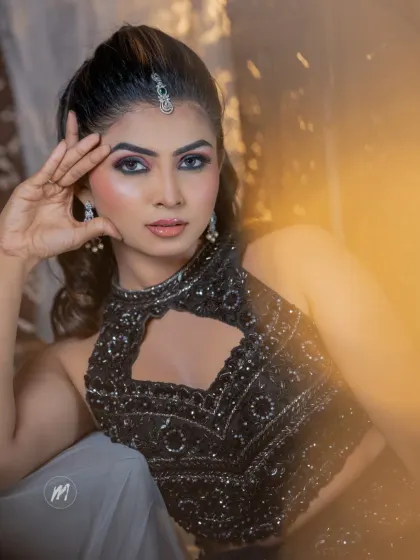A close-up portrait showing the intensity of the eye makeup and the flawless finish of the skin.