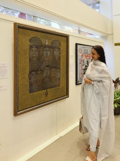 A visitor admires a large, expressive artwork, showcasing the dynamic energy and diverse perspectives present in our South Edition exhibition.