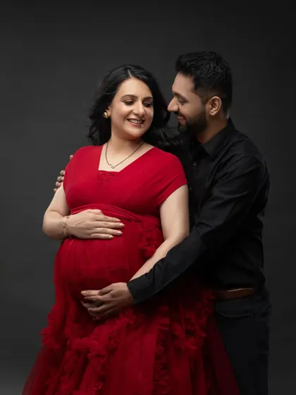 A classic couple's portrait with the elegant red ruffled gown. Their loving gaze towards each other tells a beautiful story.