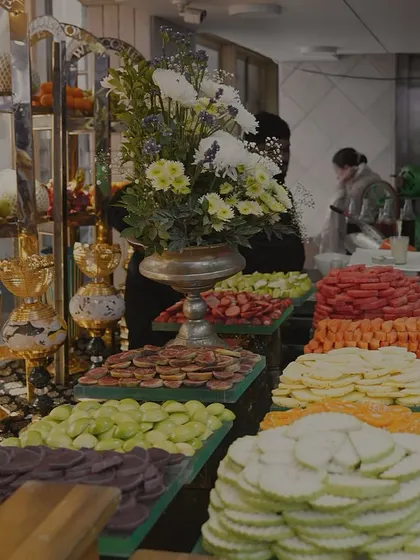 A vibrant and healthy fruit display, showcasing an abundance of freshly sliced melons, figs, and apples. We believe in offering fresh, beautiful, and delicious options for every palate.
