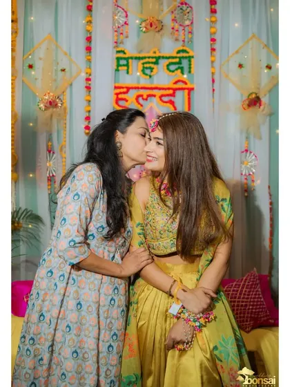 A sweet moment between the bride and a family member during the Haldi ceremony.