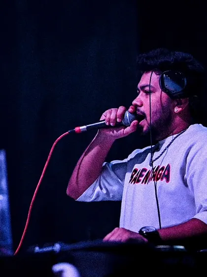 On the mic at Shimmers, connecting with the crowd.