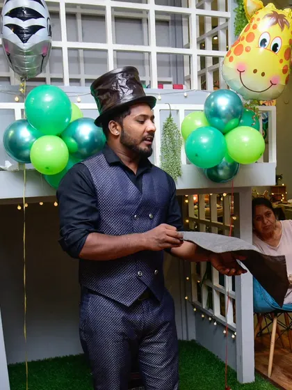 Do you believe in magic? Our magician, in his top hat, prepares to amaze the audience with his next trick.