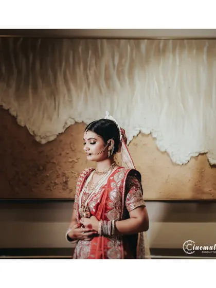 A creative bridal portrait, posing the bride against a piece of modern art to create a unique and artistic photograph.