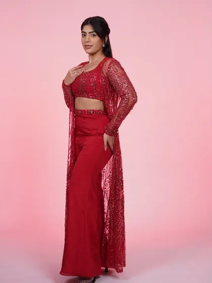 A full-length shot of the red three-piece set. The monochromatic look is so powerful and chic.