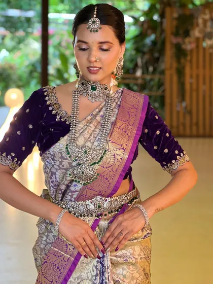 A serene, seated pose that highlights the intricate work on the velvet blouse and how it complements the jewellery.