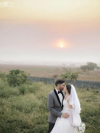 A tender kiss against a soft, golden sunset. This image showcases our ability to capture romantic, gentle moments during a Christian wedding ceremony, using natural light to create a dreamy atmosphere.