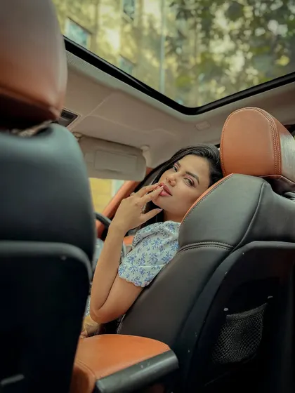 An in-car photoshoot, using the vehicle's interior and sunroof to create a unique and intimate setting.