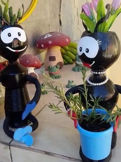 Another view of the recycled ant sculptures. The male and female figures add a narrative element to the garden decor, showcasing a playful approach to landscape art.
