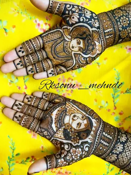 This angled view highlights the flow of the bridal story, with the couple's portraits on the palms and the narrative of their wedding rituals continuing up the arms. The yellow background makes the dark henna pop.