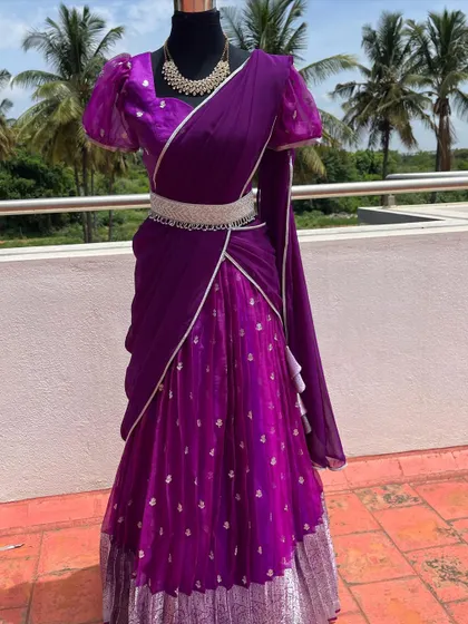 The full view of the purple half saree, showing the pleated skirt.