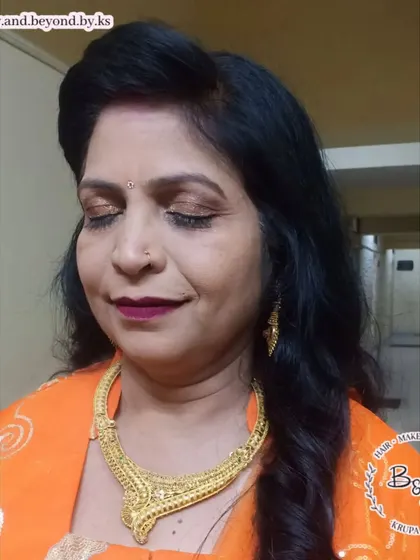 For this beautiful aunt of the bride, we went with a soft bronze smokey eye and a pop of color on the lips. I kept her base natural and simply defined her curls for a simple yet elegant hair and makeup look.