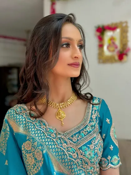 A close-up of the makeup for the 'Grah Pravesh' ceremony, with defined eyes and a soft lip color.