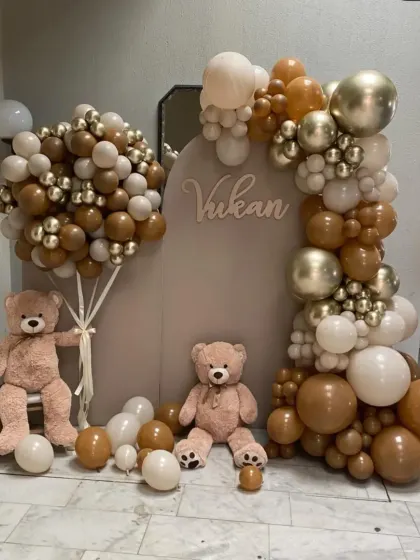 A sophisticated and modern teddy bear theme for a baby celebration. This setup uses a neutral color palette of brown, beige, and gold balloons, paired with a custom backdrop and adorable teddy bears for a chic and heartwarming look.
