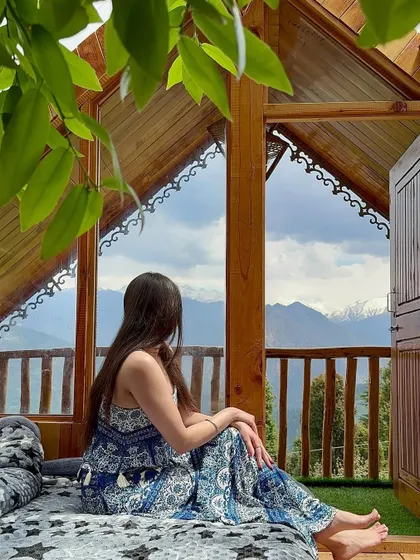 Looking out at the mountains from the cozy corner of the Bahu treehouse. This image is all about finding peace and beauty in unexpected places, a core theme of my travel content.