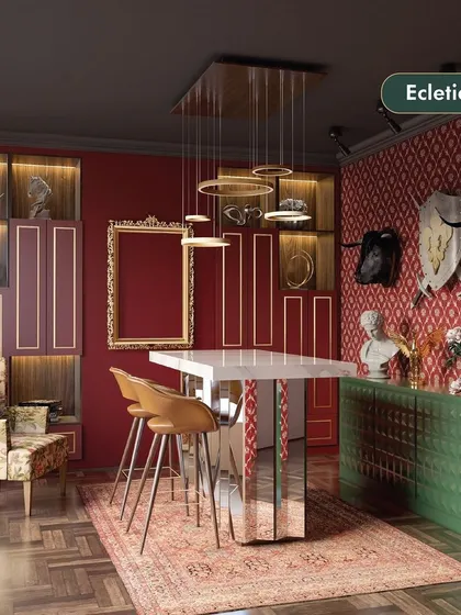This eclectic style dining area is a bold mix of colors, patterns, and textures. The design combines a red patterned wallpaper, a green console, a floral armchair, and modern metallic lighting for a unique and vibrant look.
