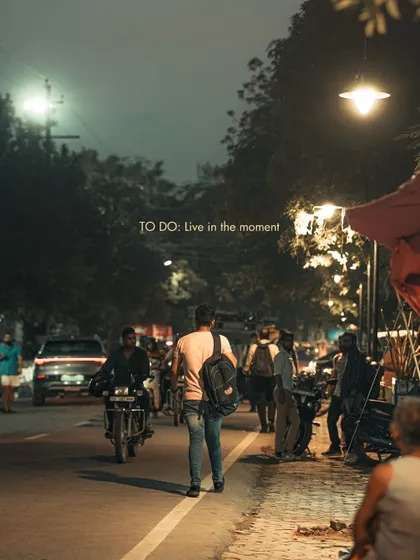A street scene at night with a simple to-do list: "Live in the moment." This is the philosophy I try to bring to my photography, capturing life as it happens.