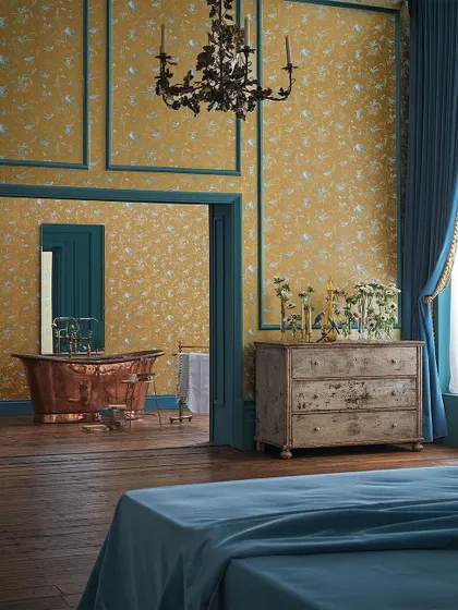 The 'Selection of Hummingbirds' collection by Cole & Son, shown here in a majestic bedroom, transforms the space into an ethereal aviary. The rich gold background and delicate birds create an atmosphere of pure opulence and enchantment.