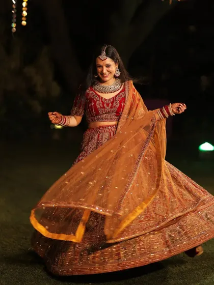 Her armor is her bridal look. A full-length shot of the bride twirling in her lehenga, full of life and joy.