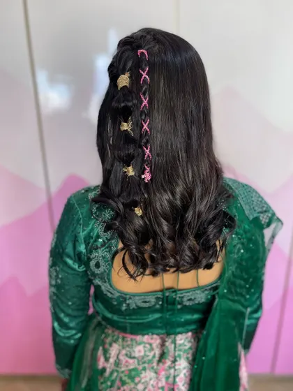 Getting creative with braids and accessories. This unique hairstyle features a delicate lace-like braid woven with pink thread and accented with gold clips for a modern and trendy look.