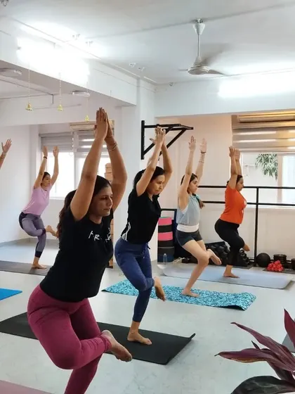 Vrksasana (Tree Pose) is a foundational balancing posture that improves focus and stability. Our students practice with calm concentration.