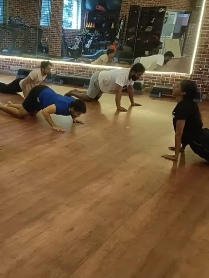 Our group yoga class finding their flow with the Bhujangasana, or cobra pose. These sessions are designed to improve flexibility and core strength, providing a perfect balance to our high-intensity workouts.