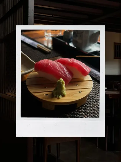 The quality of our ingredients is paramount. This simple, elegant presentation of Tuna Nigiri showcases the freshness of the fish, served on a bed of perfectly seasoned rice. It's a small bite that speaks volumes about our dedication to authentic flavor.