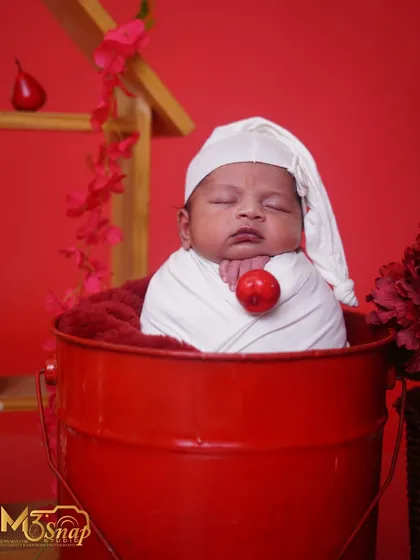 Adding a small prop like this red berry brings a touch of whimsy to the photo, complementing the red theme perfectly.